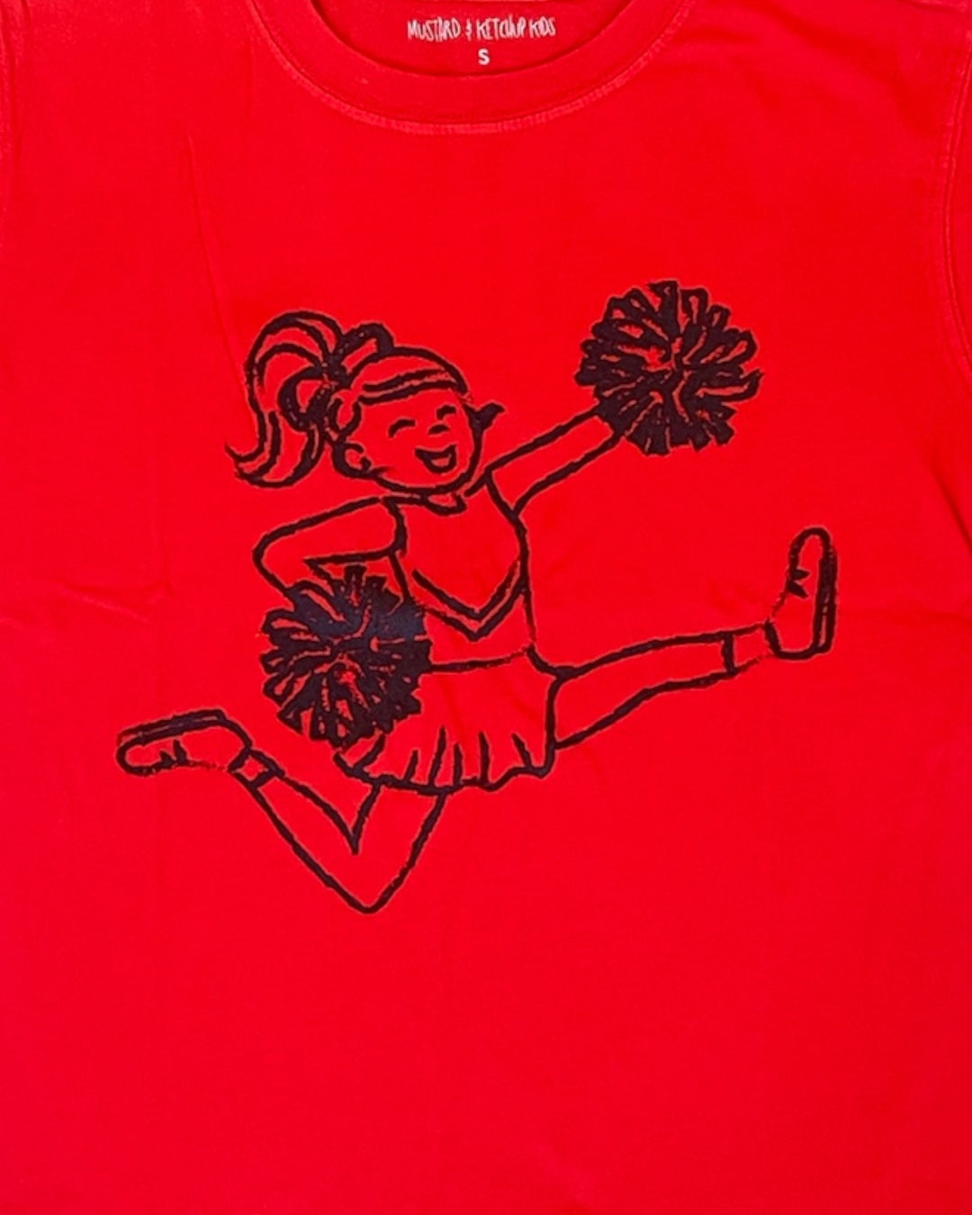 Red shirt with black outline of a cheerleader design on a red background