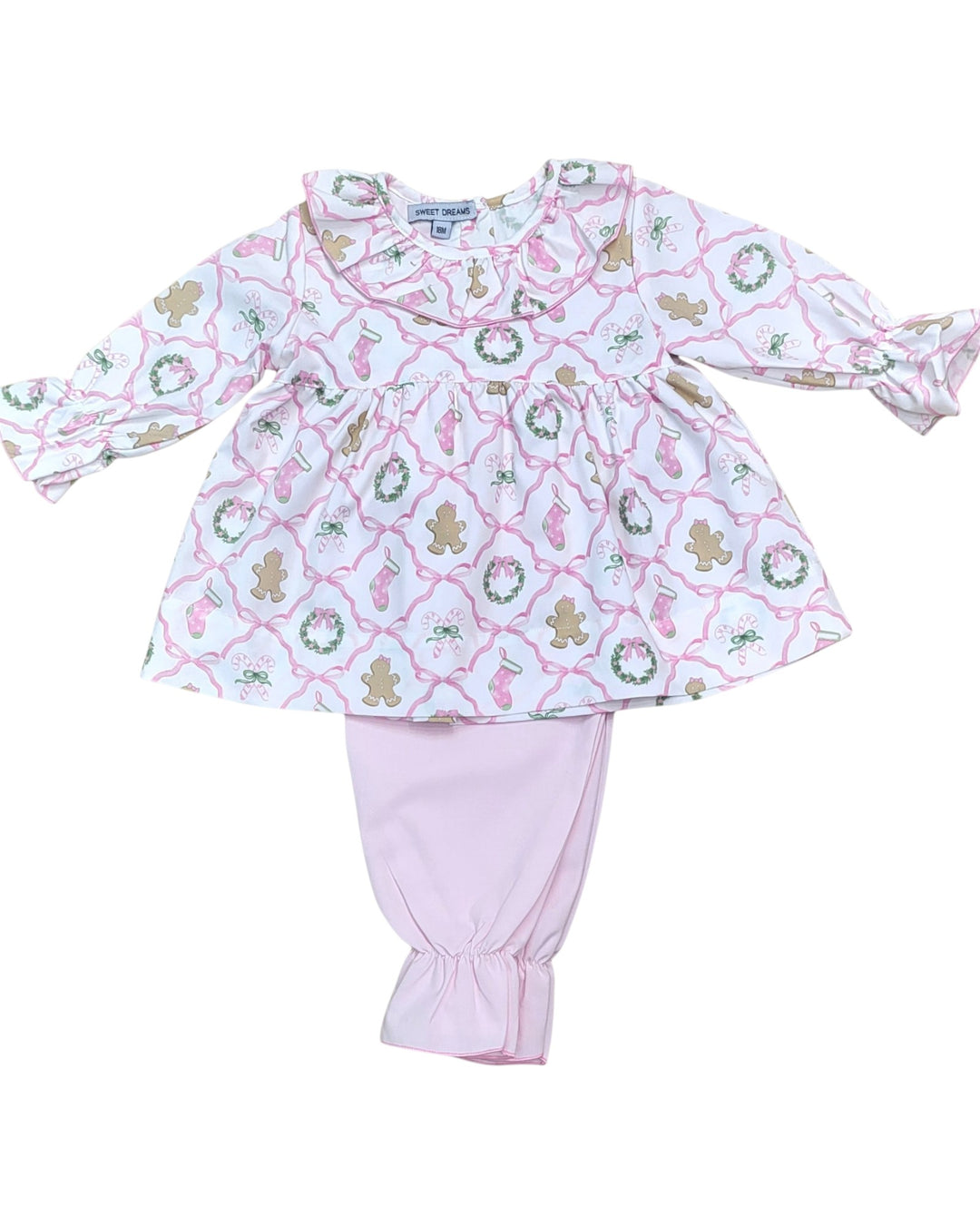 Children's outfit with patterned top and pink pants on a white background