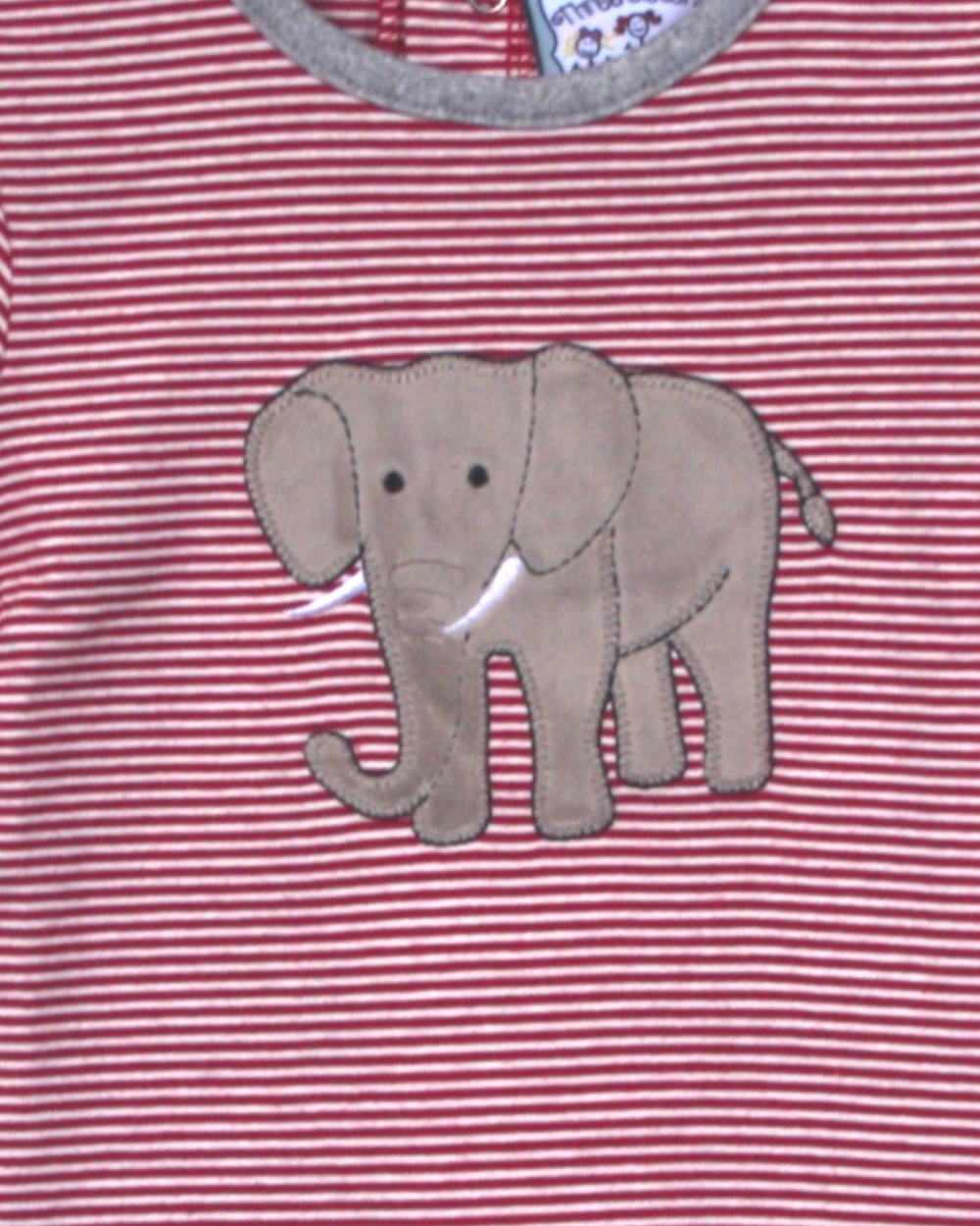Red and white striped shirt with an elephant applique on a pink background