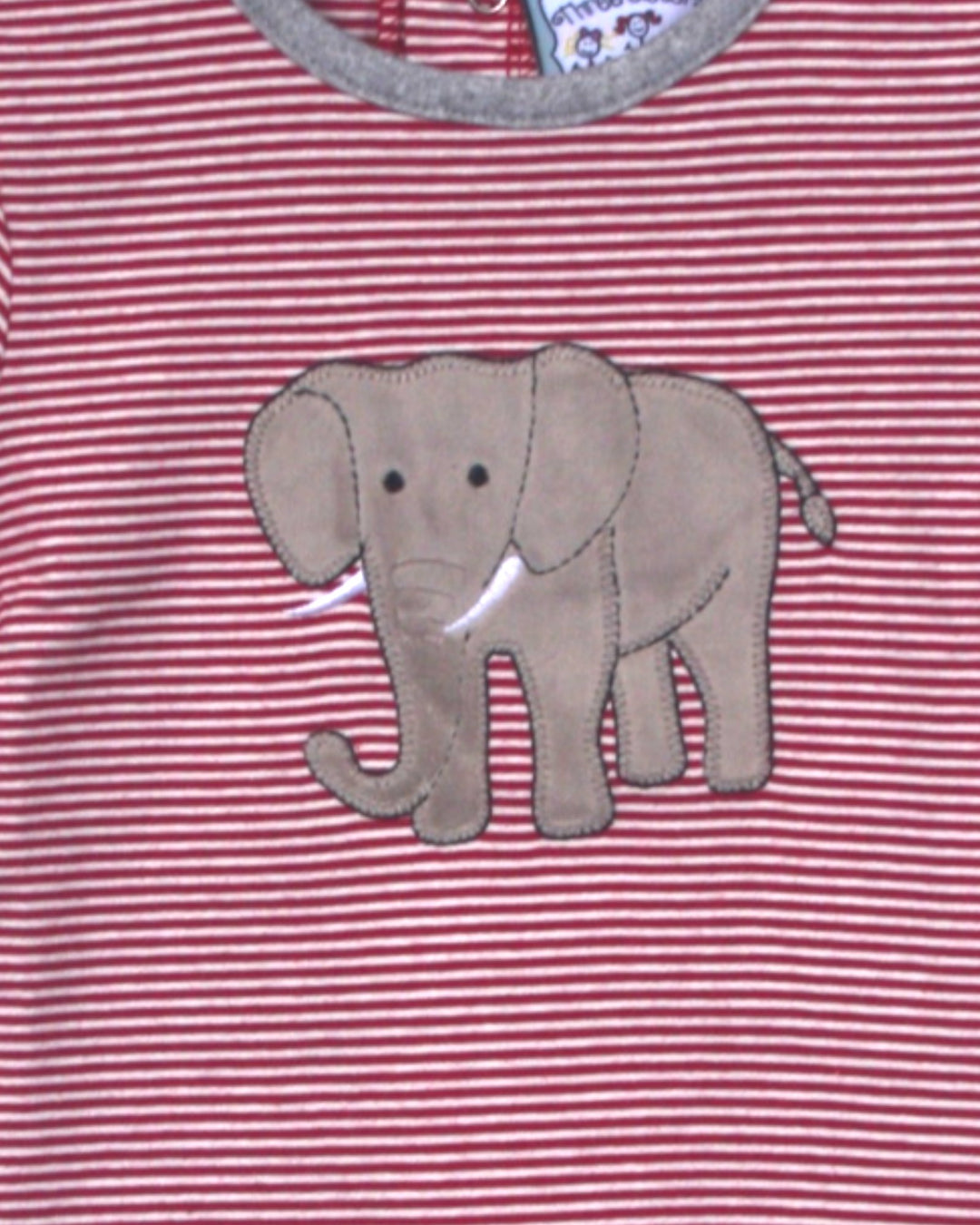 Red and white striped shirt with an elephant applique on a pink background