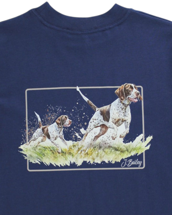 Navy blue shirt with a graphic of two dogs on grass and a signature at the bottom right corner.