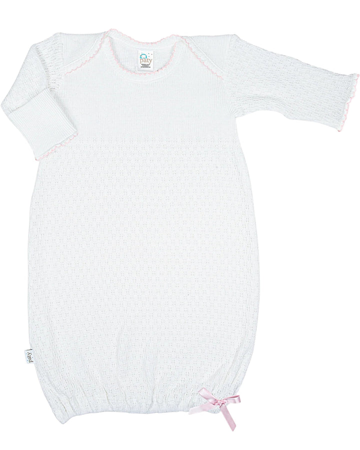 White baby romper with pink bow on a white background
