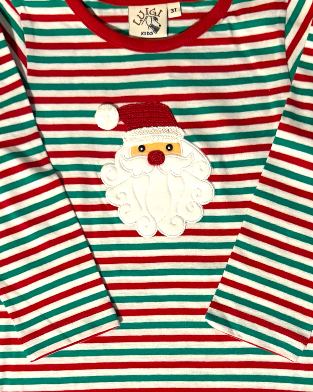 Striped shirt with Santa Claus patch on a red, green, and white background
