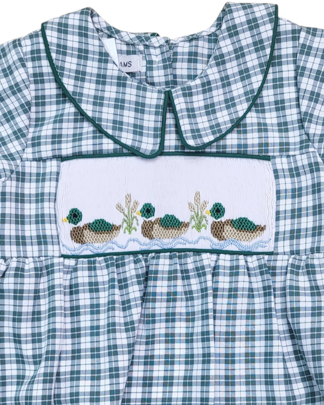 Green and white checkered dress with embroidered design on a plain background