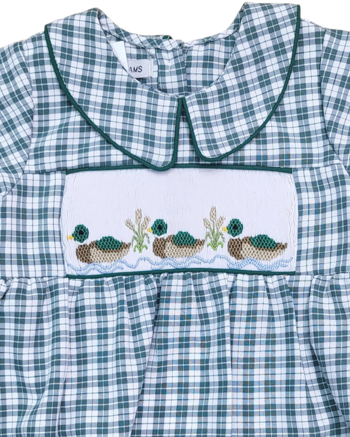 Green and white checkered dress with embroidered design on a plain background