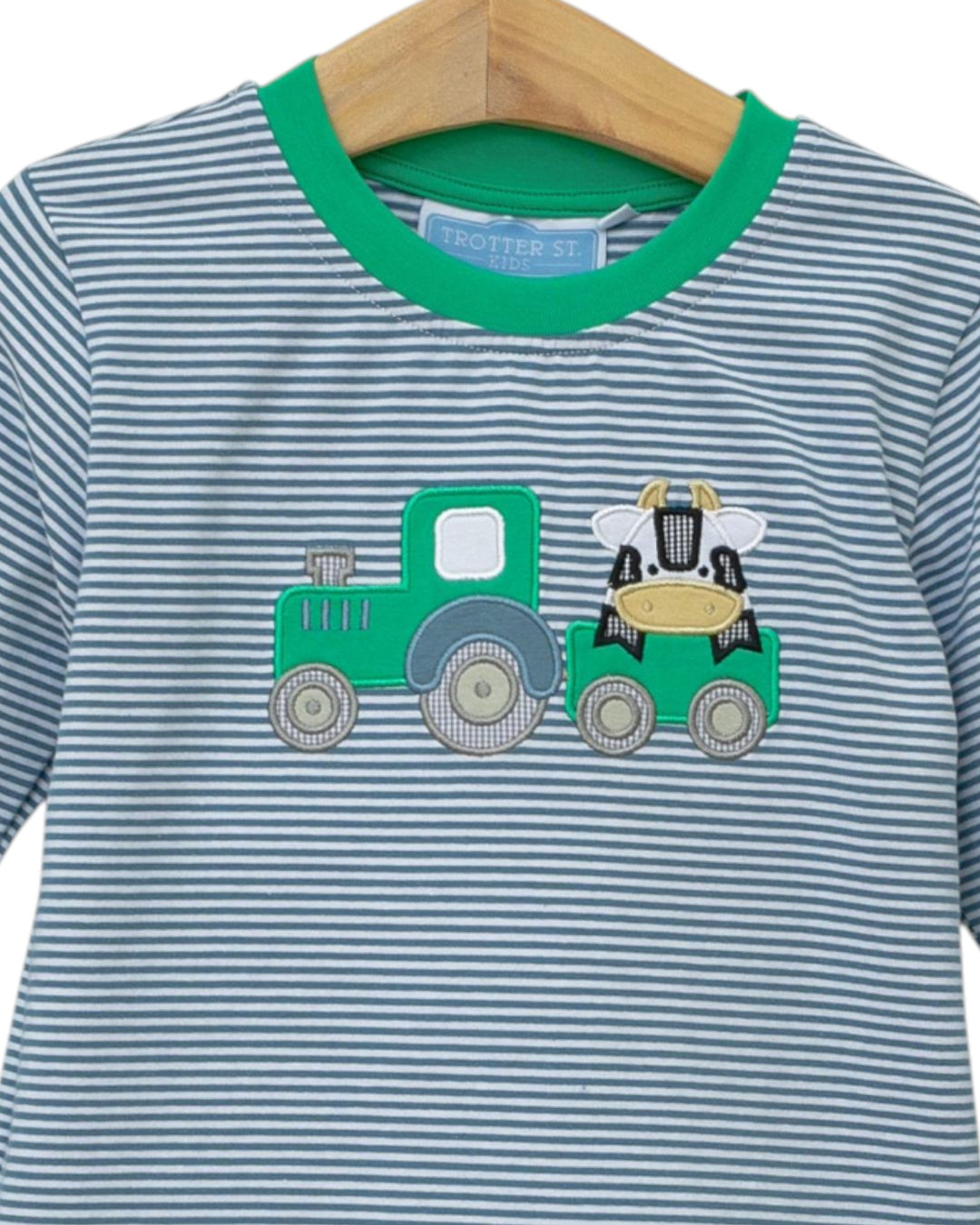 Striped shirt with a tractor design on a hanger