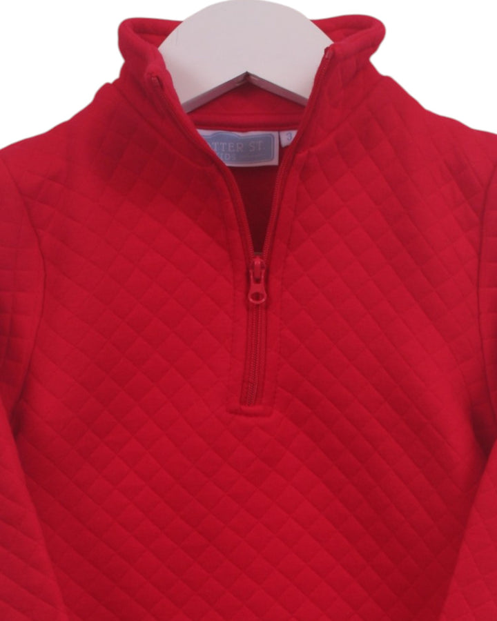 A red quilted quarter-zip pullover sweater displayed on a white hanger against a white background, that store