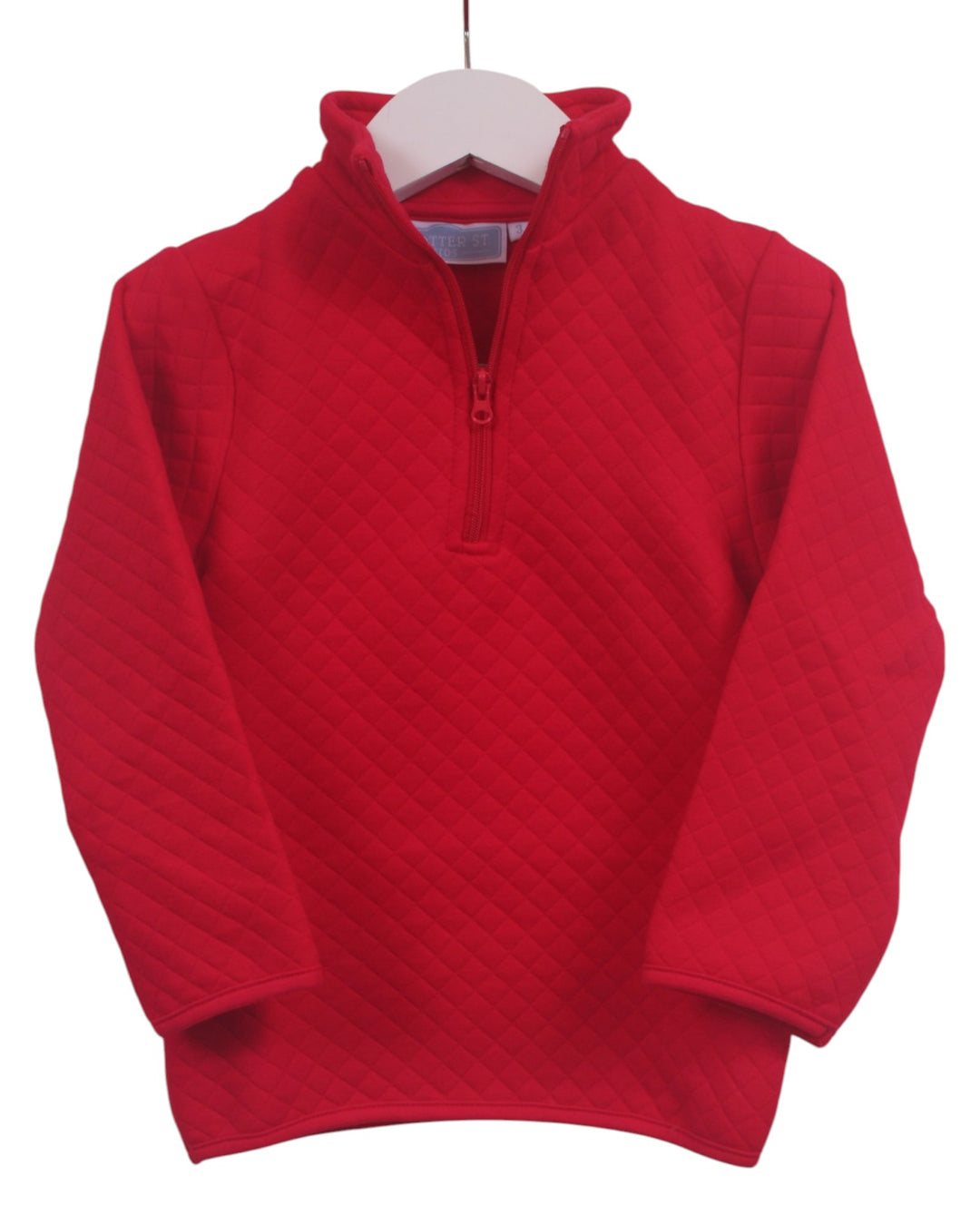 A red long-sleeve quilted quarter-zip pullover sweater hanging on a white hanger against a plain white background, that store