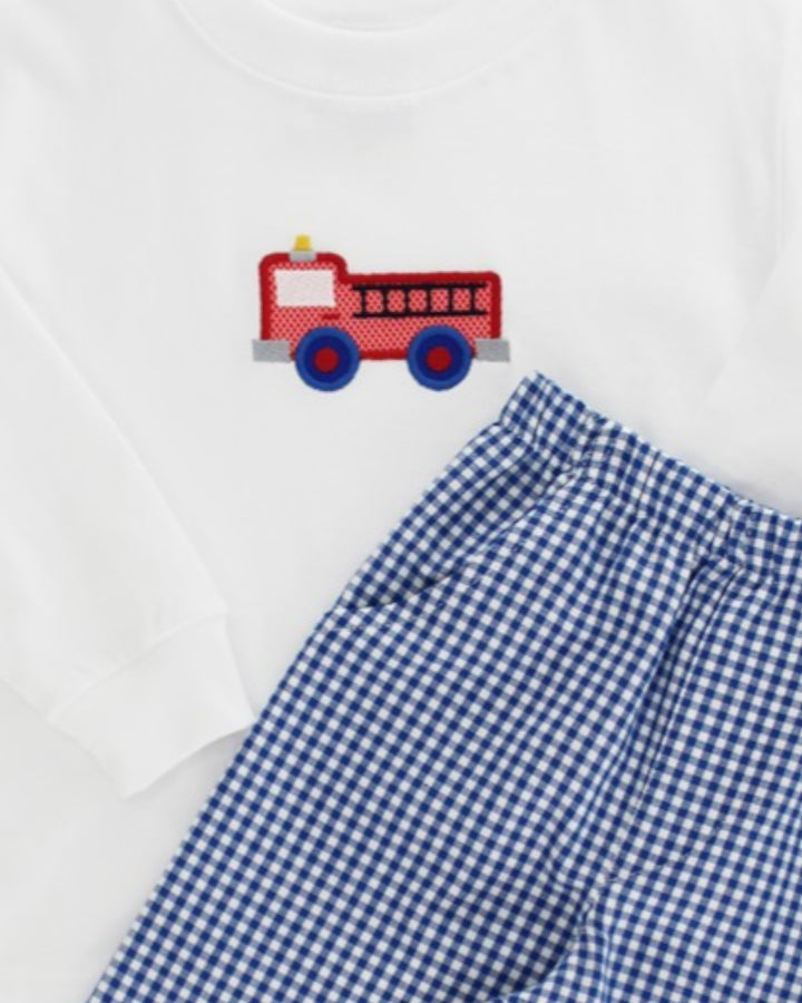 Blue gingham pants with a red fire truck applique on a white background