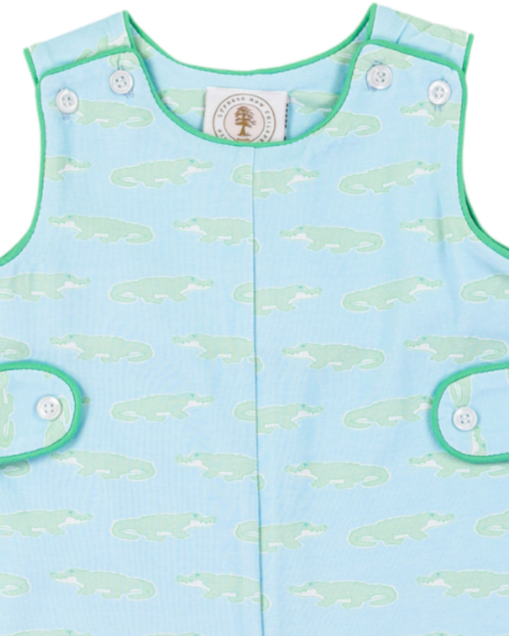 Light blue children's sleeveless shirt with green whale pattern on a white background