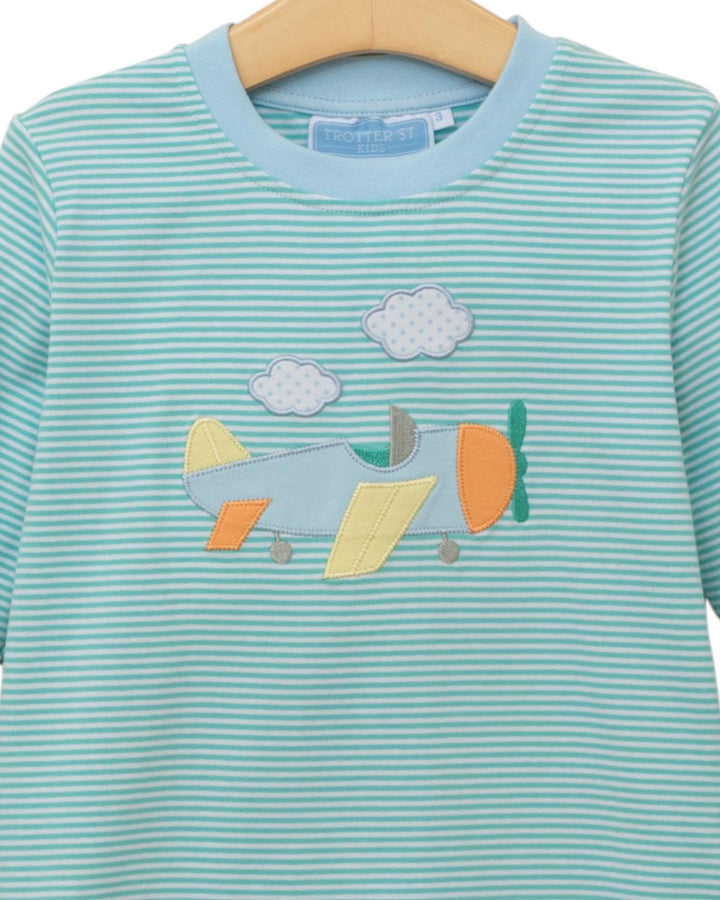 Children's shirt with airplane and cloud design on a hanger