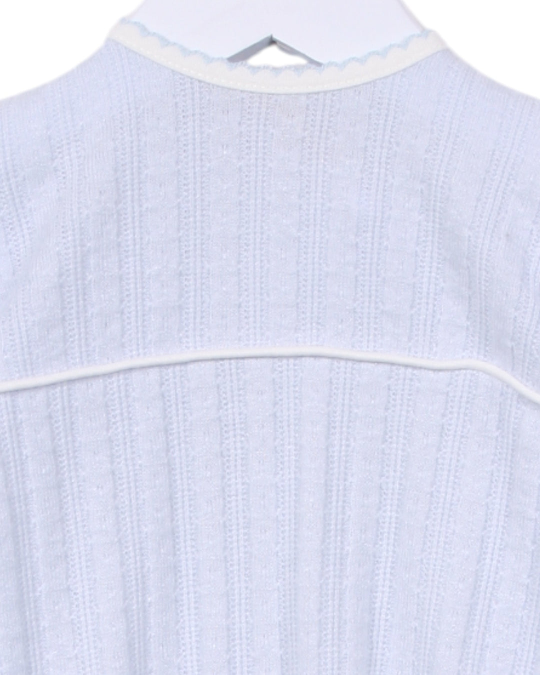 Light blue textured shirt on a hanger with a white background