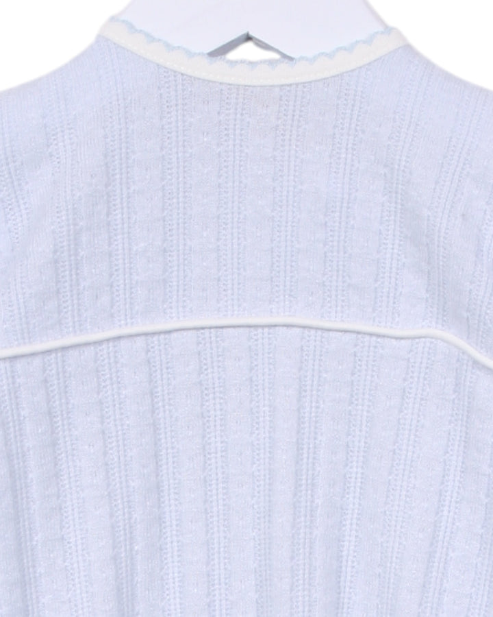 Light blue textured shirt on a hanger with a white background