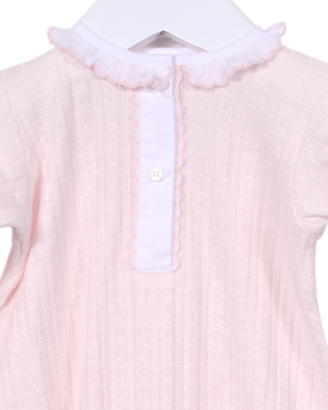 Pink baby outfit with white collar on a hanger