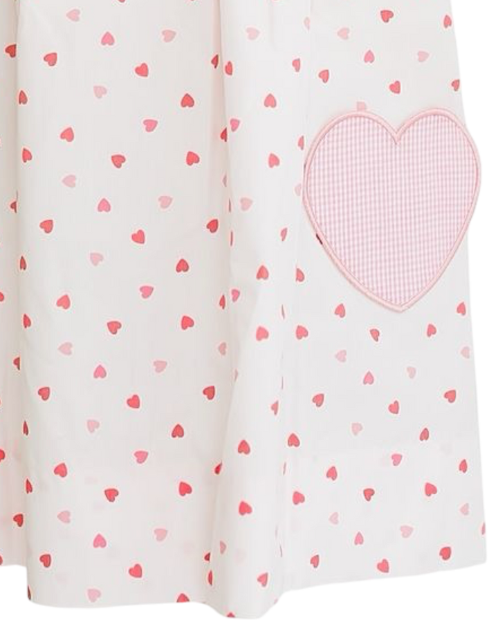 Fabric with heart pattern and a larger pink heart patch on a white background