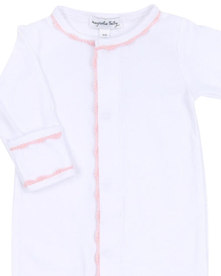 White baby onesie with pink accents on a white background