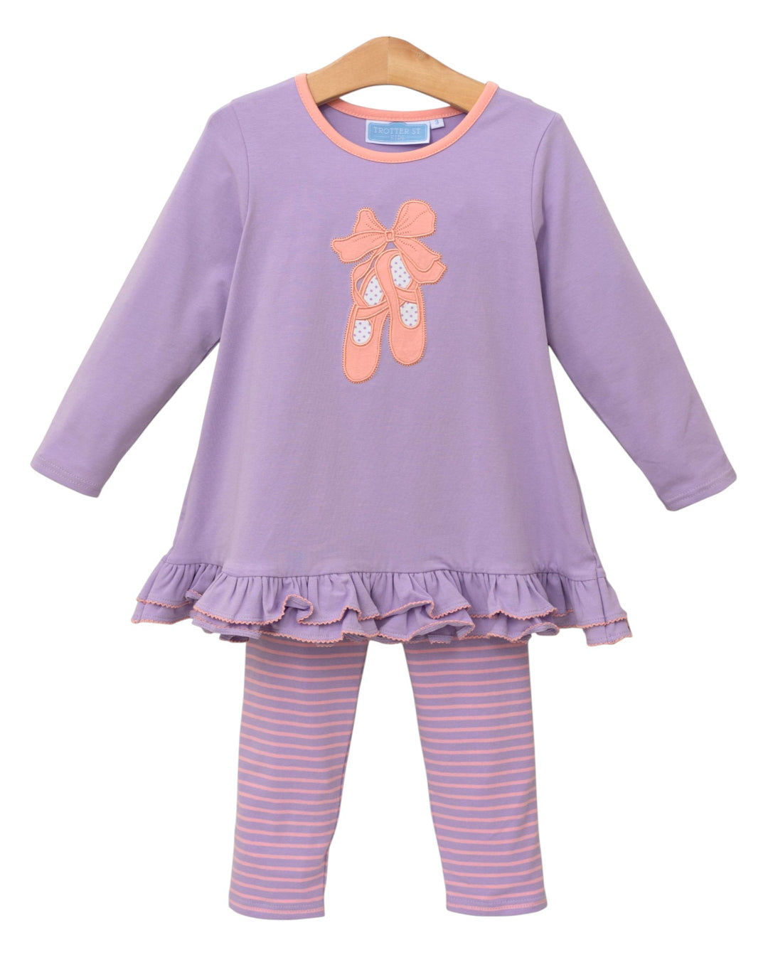 Children's outfit with purple top and striped pants on a white background
