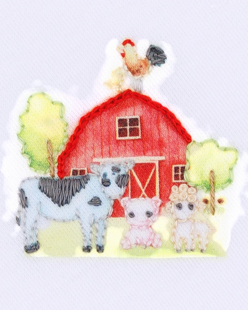 Embroidered patch with farm animals and a red barn on a white background