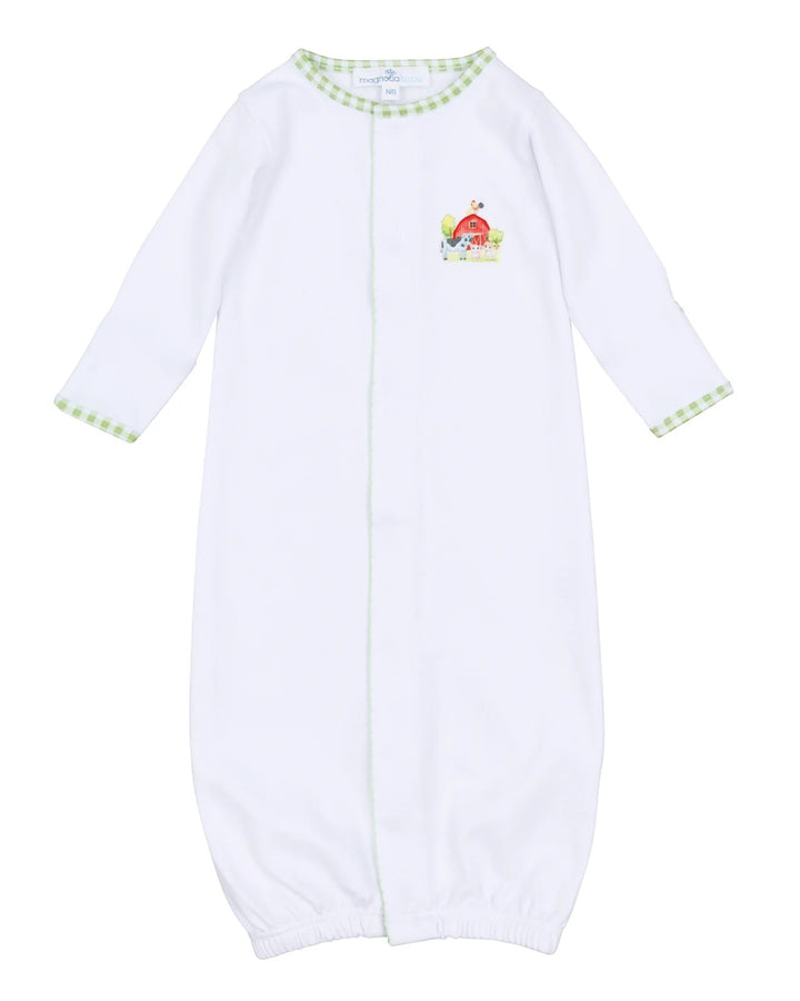 White baby onesie with green trim and a small design on a white background