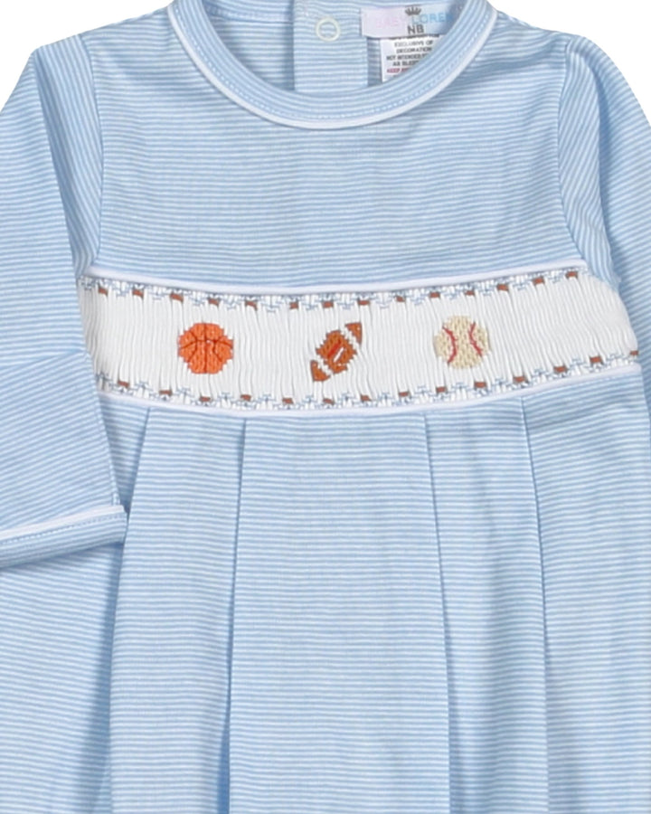 Light blue dress with a decorative white band featuring orange and brown patterns on a plain background.