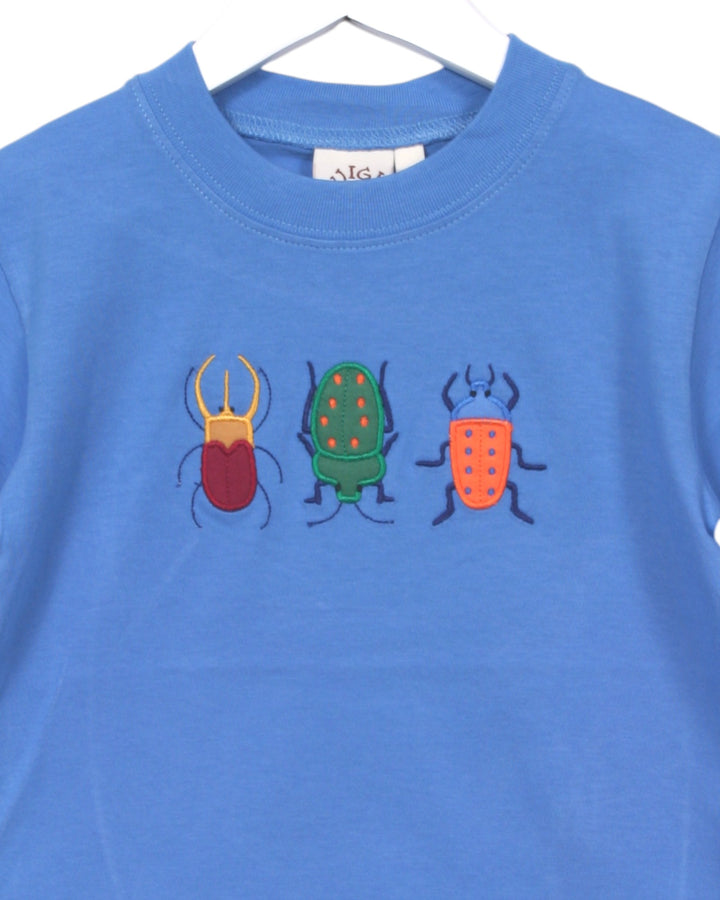 Blue t-shirt with colorful beetle designs on a white background