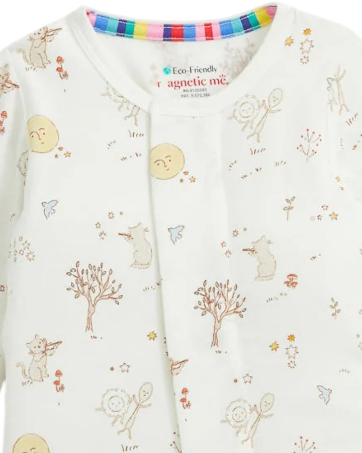 Close-up of a baby sleepwear top with a white background and a colorful cartoon print of animals, trees, and stars. The inner collar features a striped trim in multiple colors, and the brand label reads &