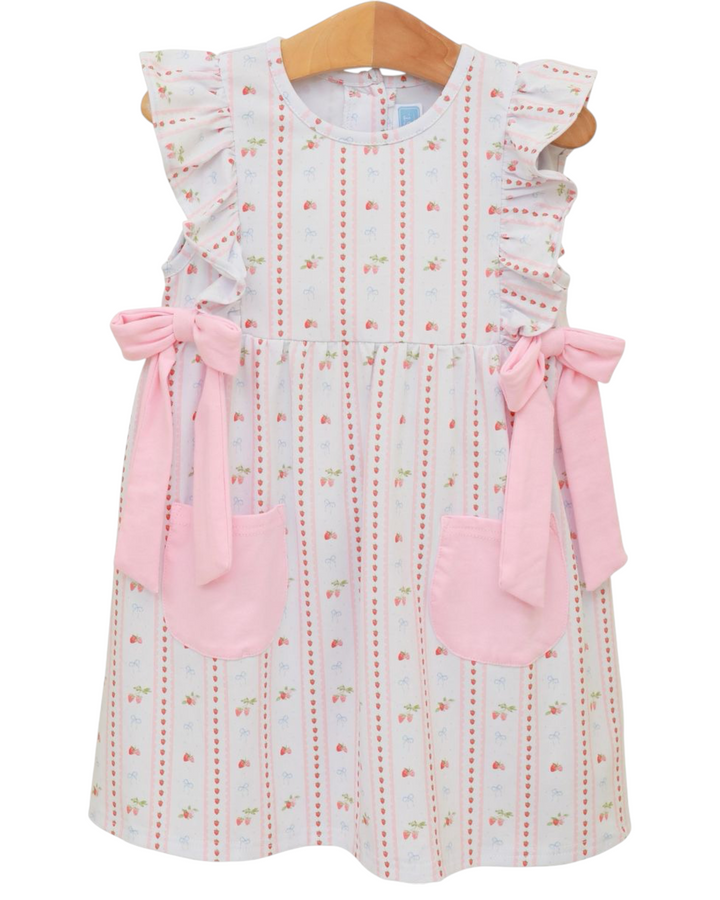 Children's dress with floral pattern and pink accents on a white background