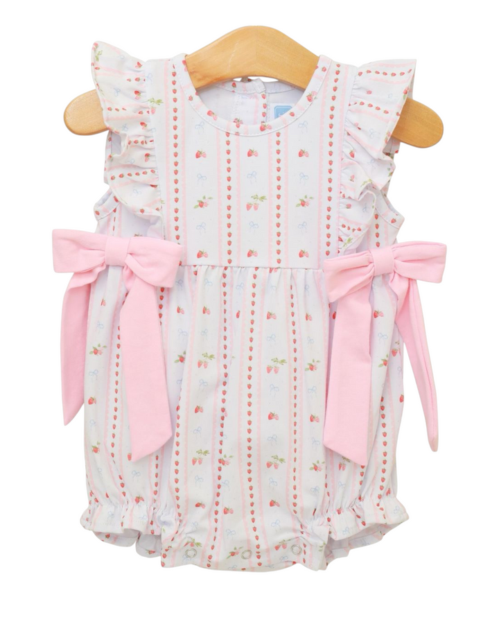 Baby romper with floral pattern and pink bows on a hanger