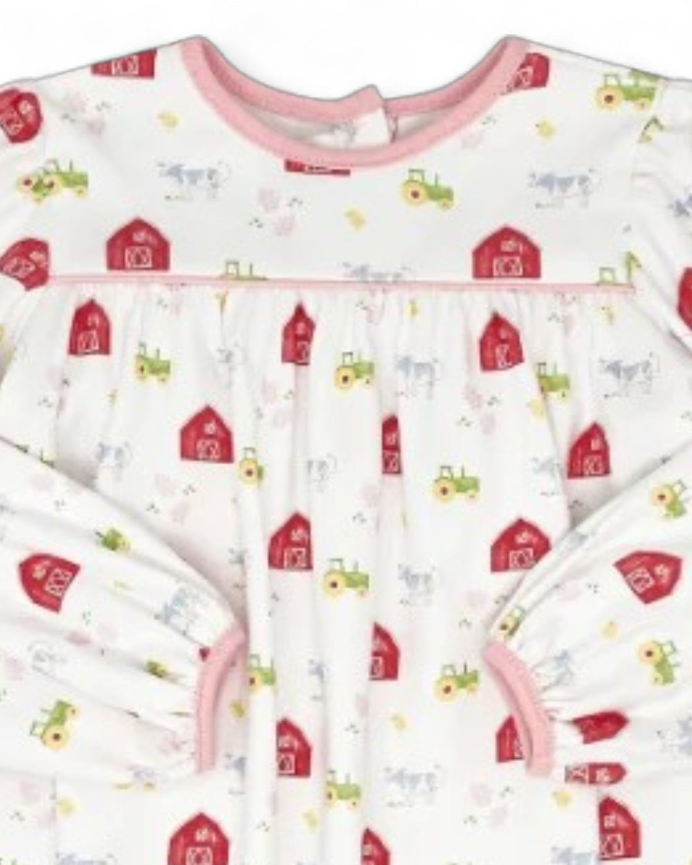 A long-sleeve baby sleep sack with a white background and a colorful farm-themed print featuring red barns, green tractors, and light blue cows. It has pink trim along the neckline, underbust, and sleeve cuffs, that store