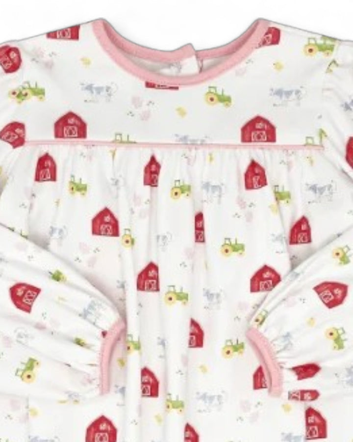 A long-sleeve baby sleep sack with a white background and a colorful farm-themed print featuring red barns, green tractors, and light blue cows. It has pink trim along the neckline, underbust, and sleeve cuffs, that store