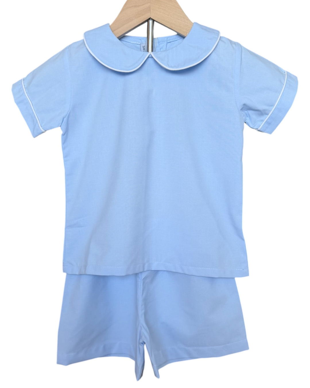 Light blue children's outfit with a collar on a white background