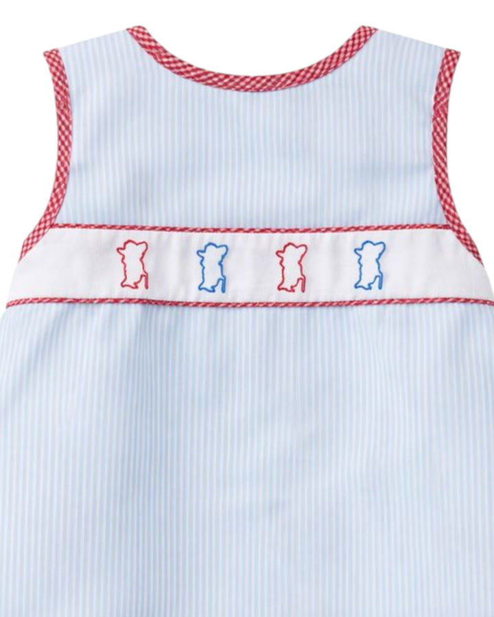 Light blue sleeveless dress with red trim and embroidered bears on a white background