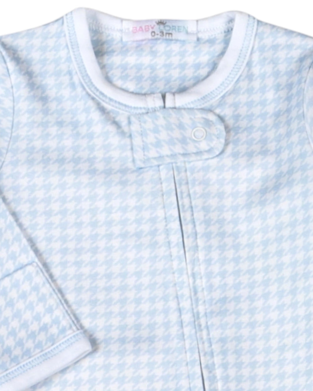 A close-up of a baby sleep sack featuring a light blue and white houndstooth pattern, with a snap-button closure at the collar, that store