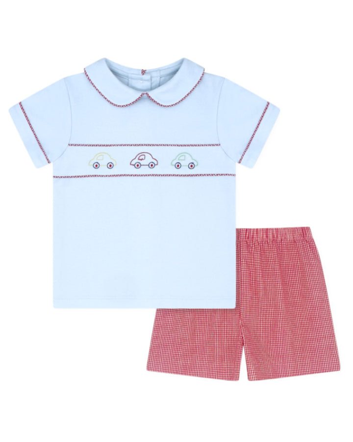 Children's outfit with light blue shirt and red checkered shorts on a white background
