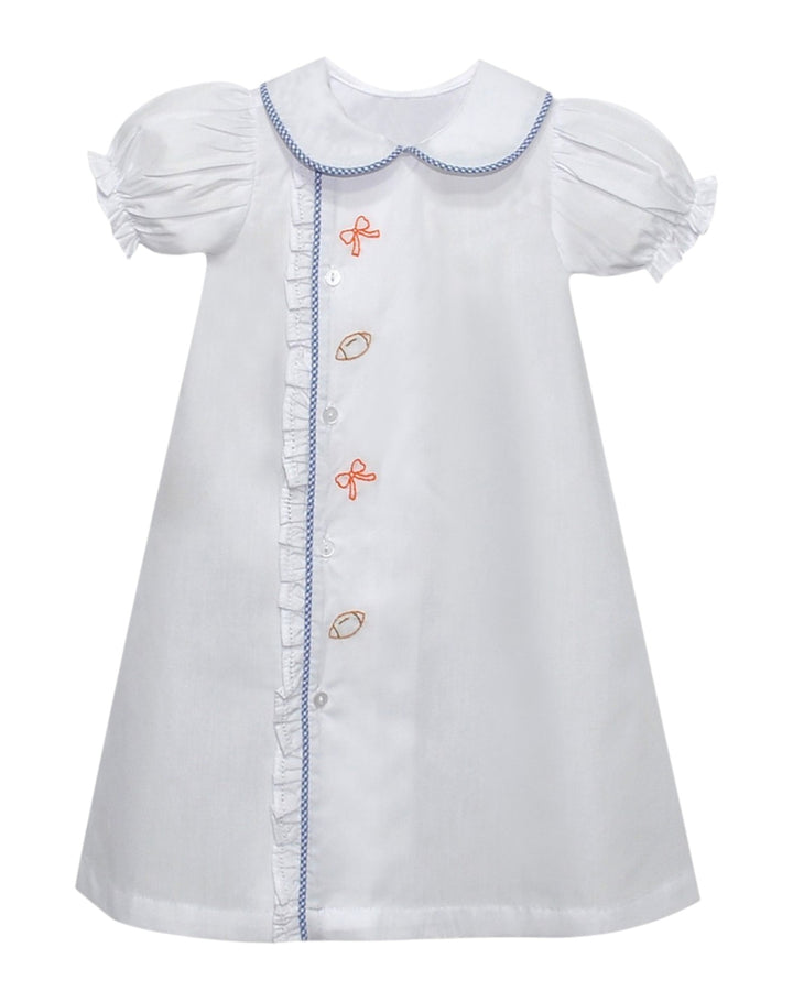 White dress with embroidered details on a white background