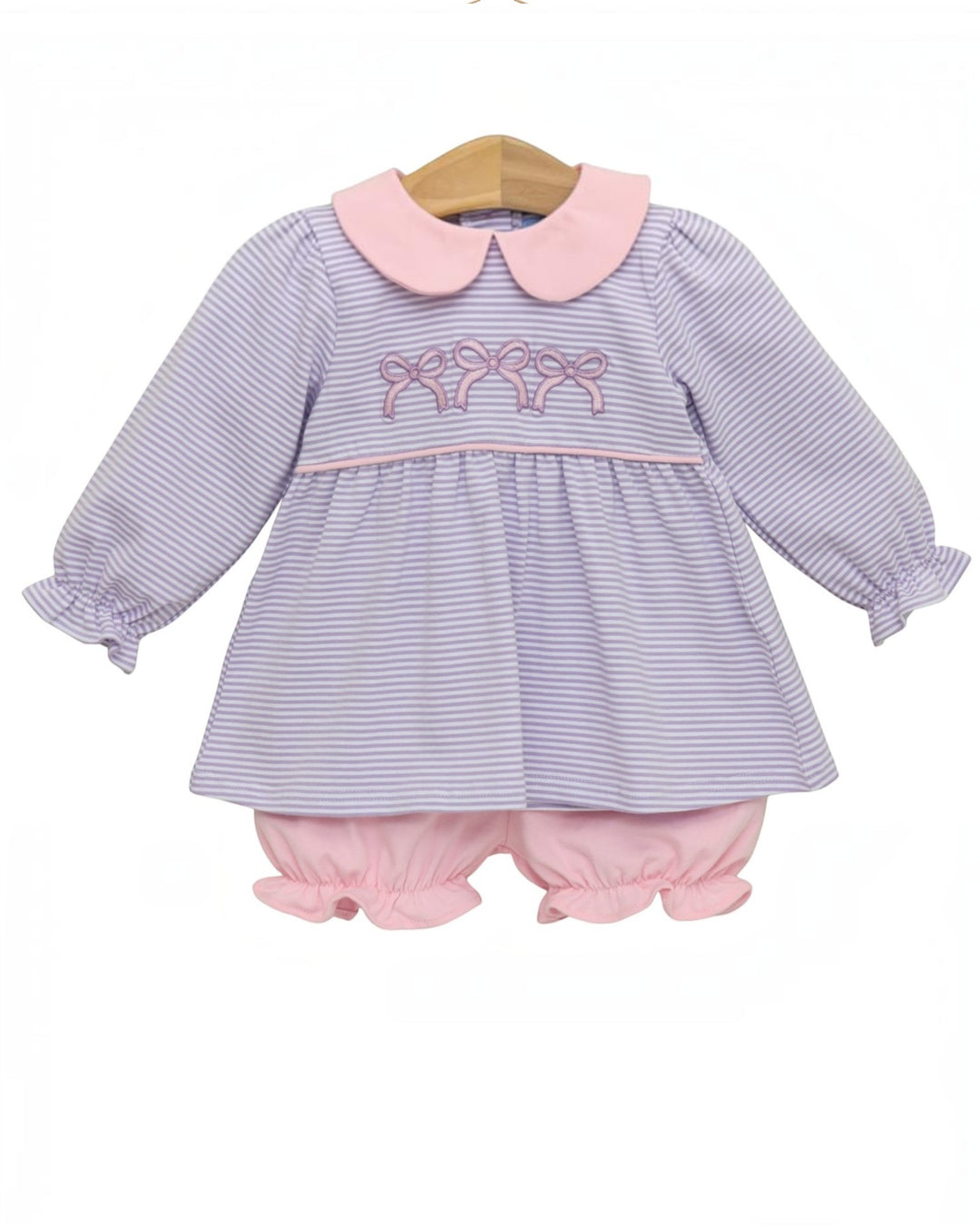 A baby girl's two-piece outfit consisting of a long-sleeve top and matching bloomers. The top features a lavender and white striped body with a light pink Peter Pan collar and pink embroidered bows across the chest, that store