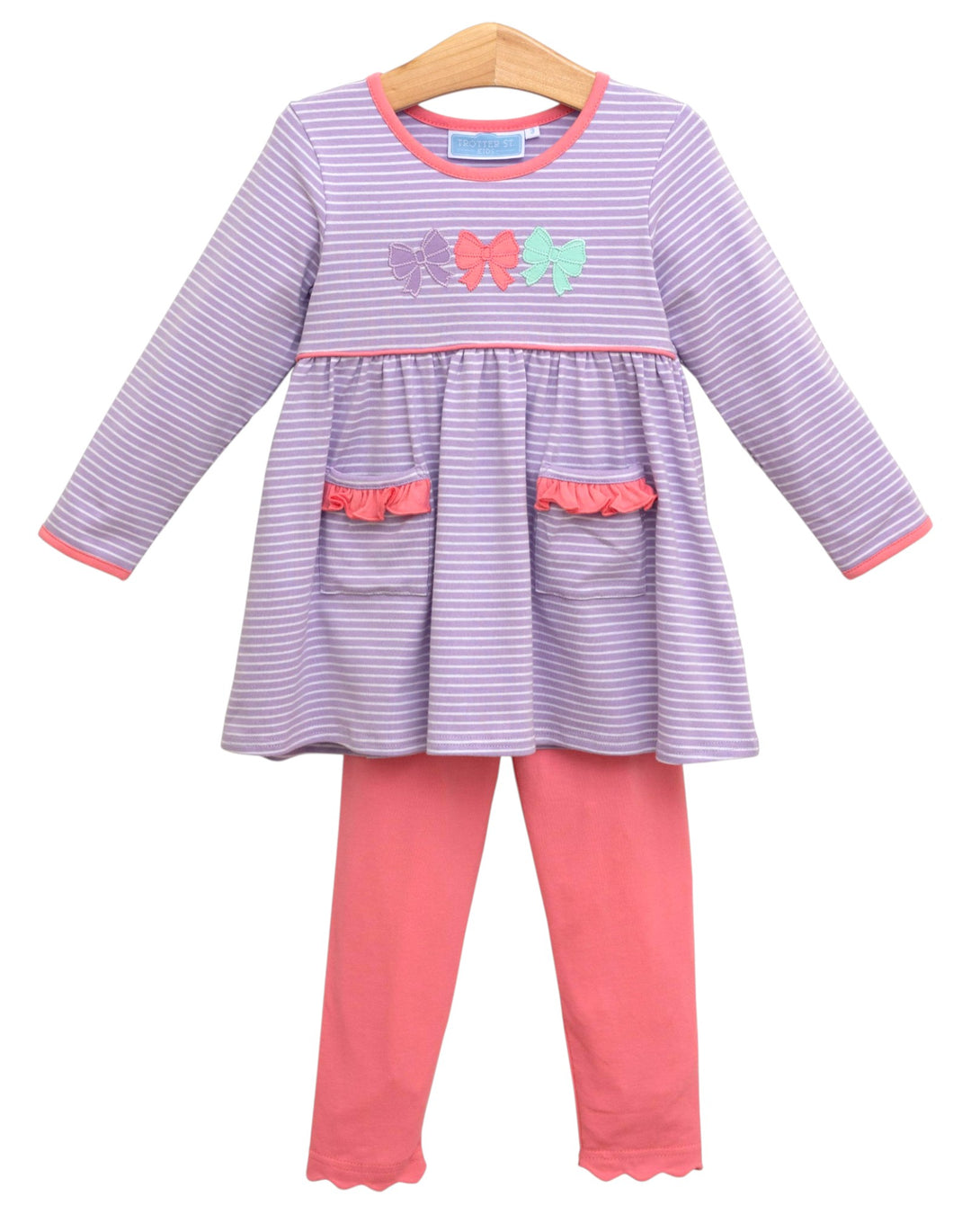 Children's outfit with purple and pink dress and leggings on a white background