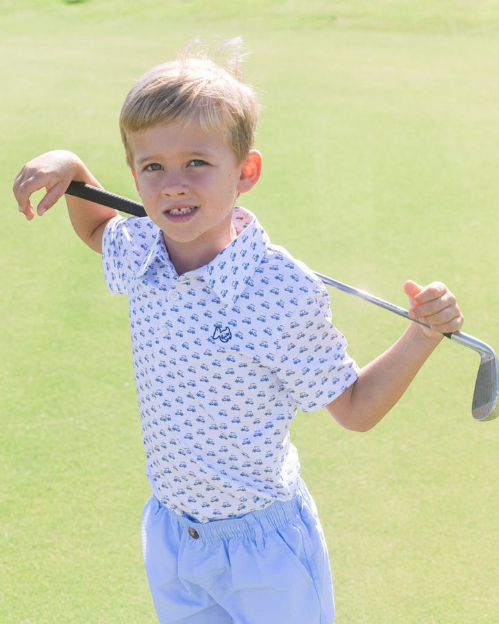 Young boy holding a golf club on a golf course