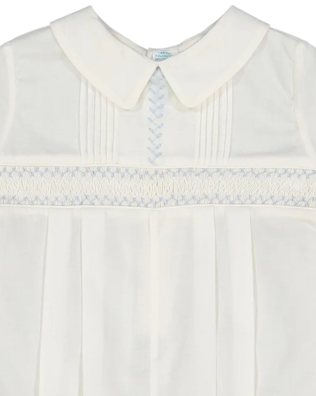 White dress with a smocked collar and trim on a white background