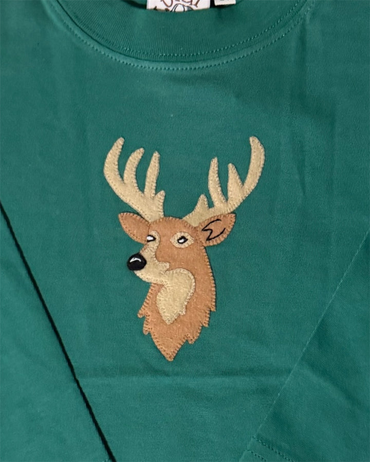 Green shirt with a deer head patch on a green background