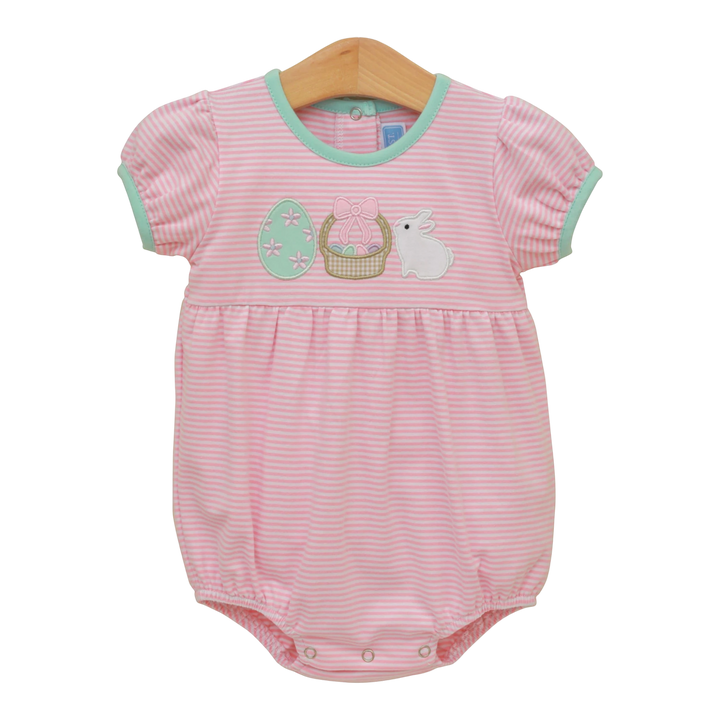 Pink striped baby romper with Easter design on a wooden hanger