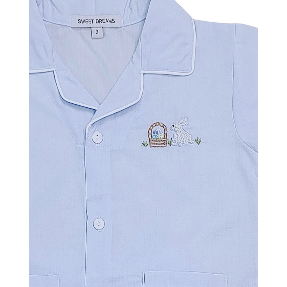 Light blue pajama top with embroidered design and 'Sweet Dreams' label.