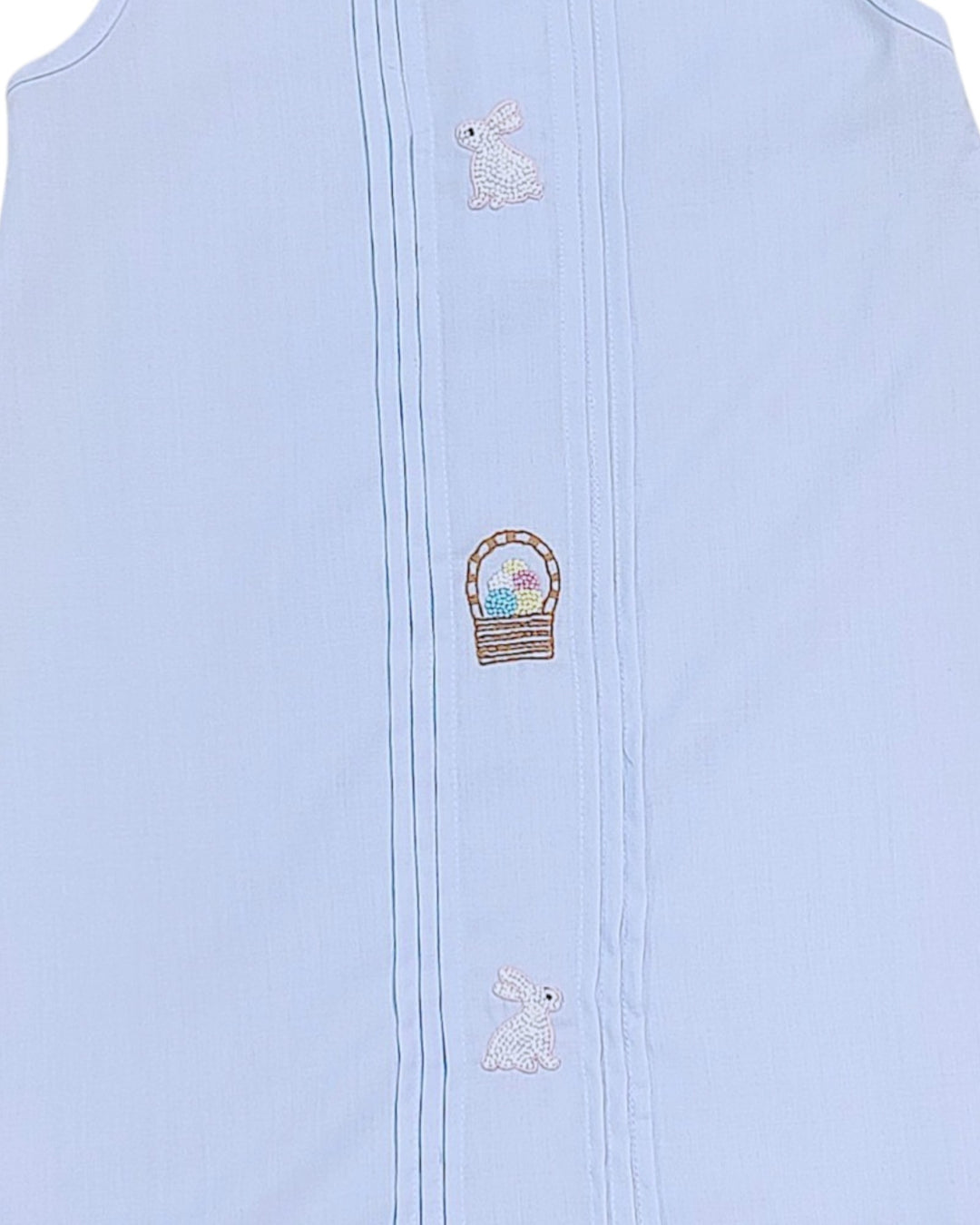 Light blue sleeveless garment with embroidered designs on a white background