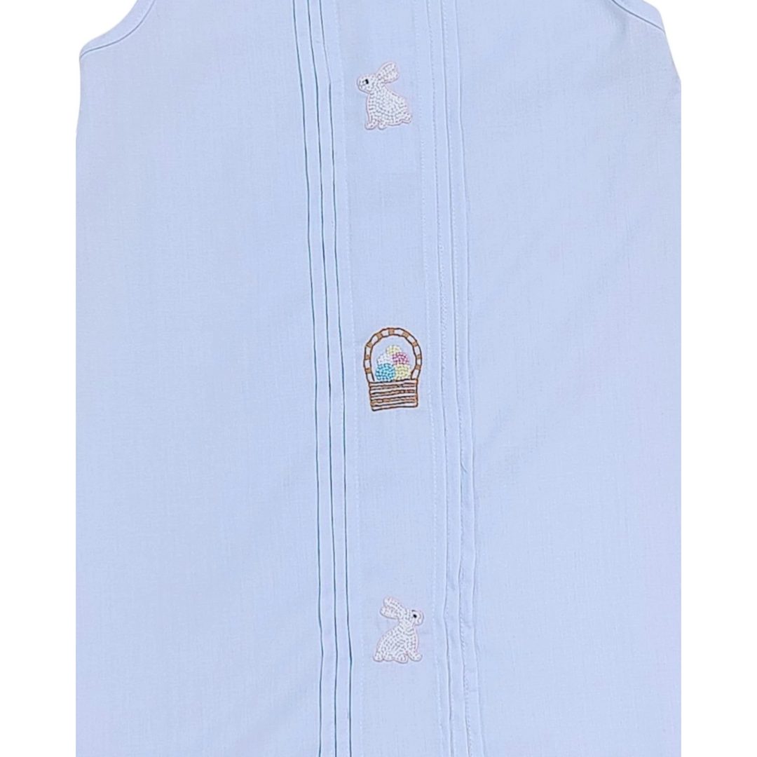 Light blue sleeveless garment with embroidered designs on a white background
