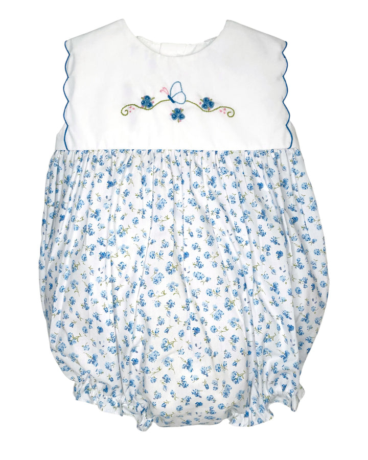 Baby romper with blue floral pattern and white top on a white background