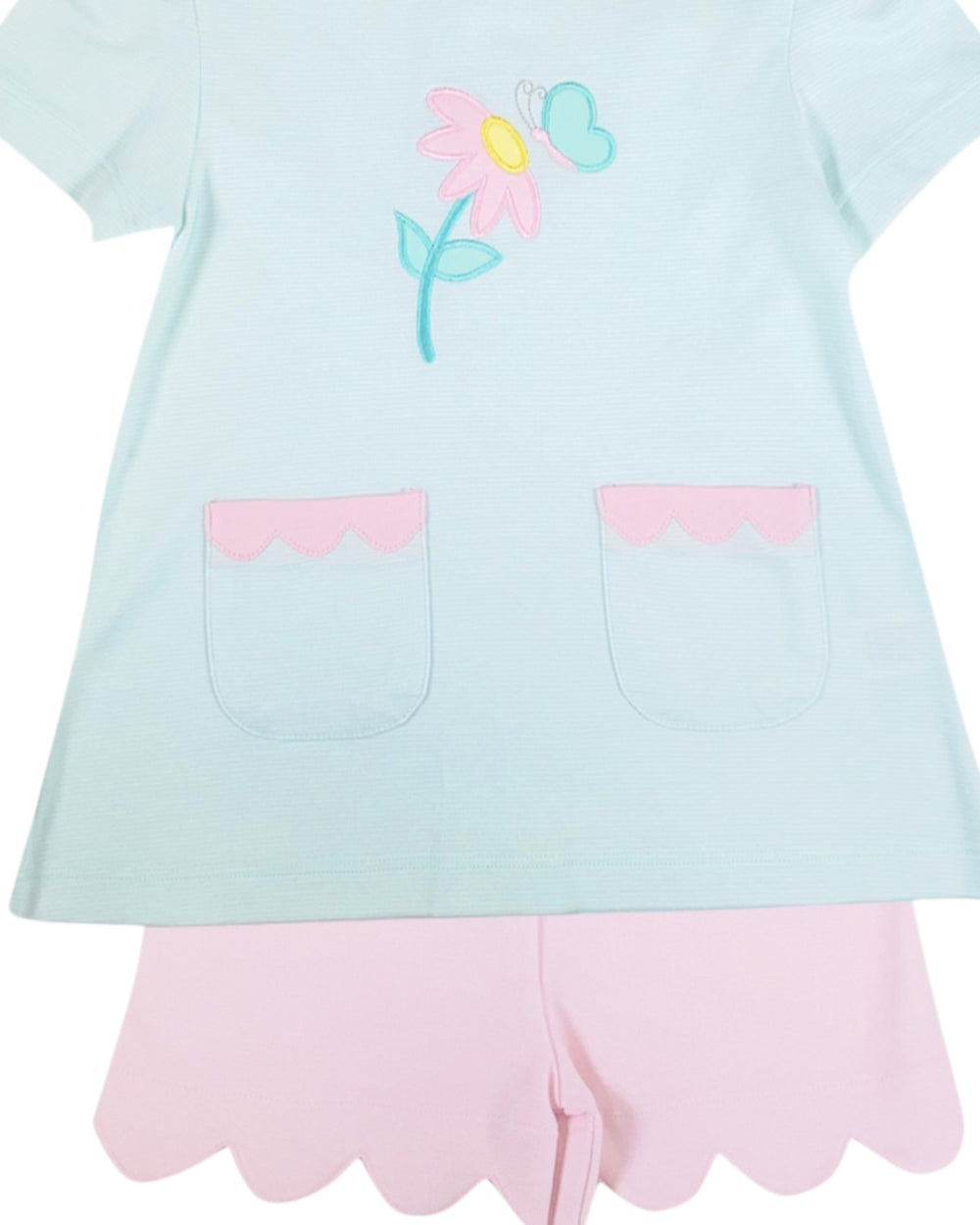 Light blue top with floral design and pink shorts on a white background