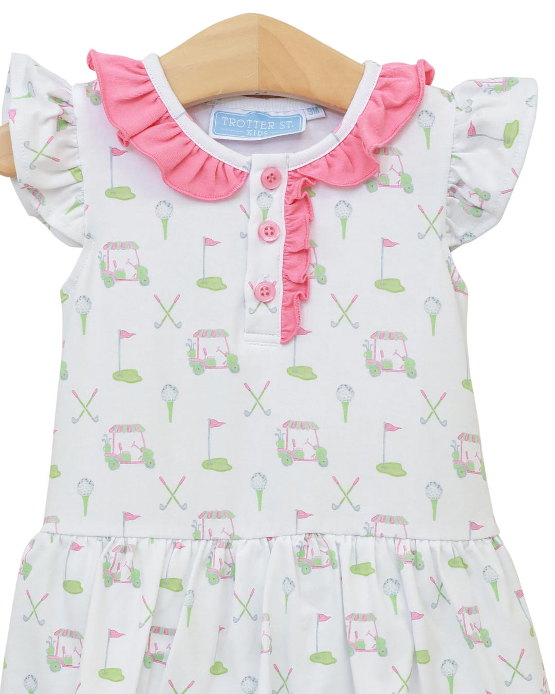 Baby dress with golf cart and flag pattern on a white background
