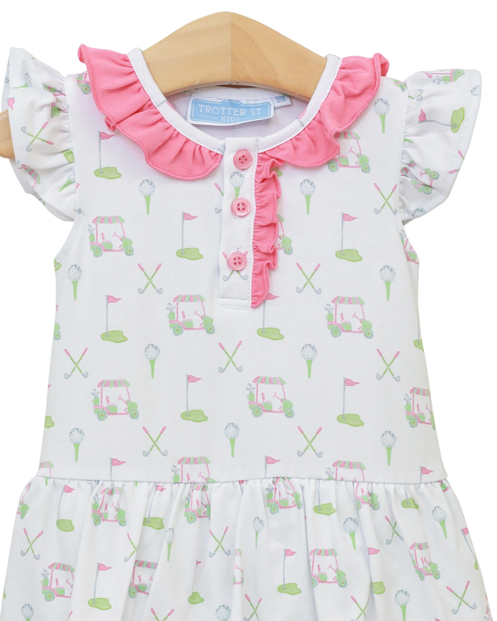 Baby dress with golf cart and flag pattern on a white background