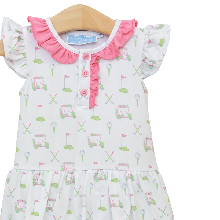 Baby dress with golf cart and flag pattern on a white background
