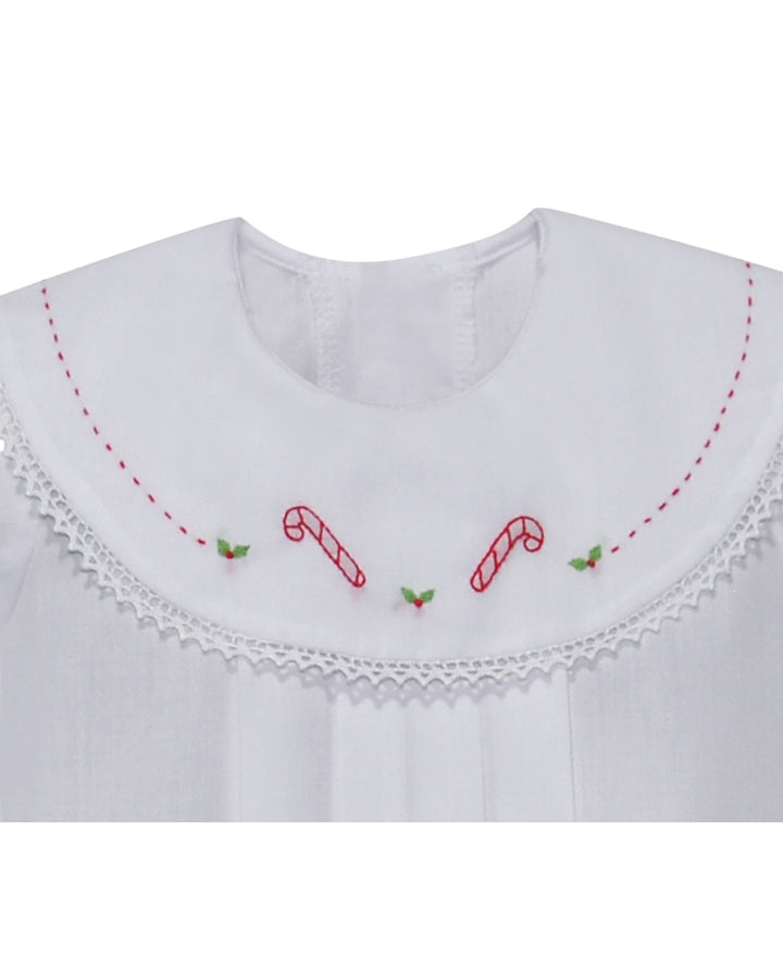 White garment with red candy cane and green leaf embroidery on a white background